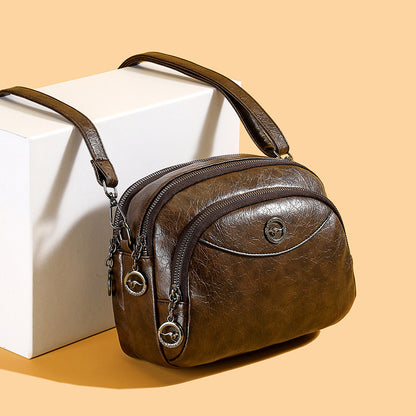 👜Bolso de mano compacto de piel con múltiples compartimentos, modelo 2026.